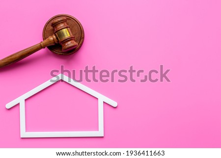 Insurance mortgage law concept. House shape with judges gavel