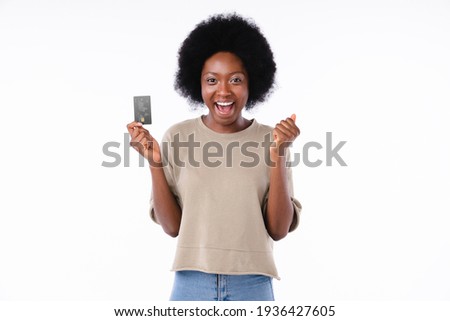 Extremely happy young african girl holding credit card isolated in white