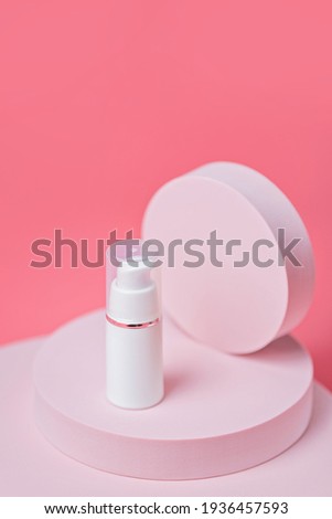 Cosmetic Oil on podium at pink background. Stylish background for presentation. Minimal style.