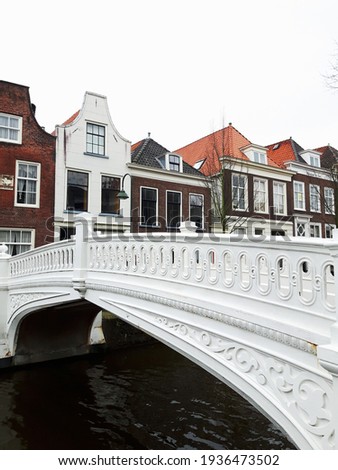 A White bridge crossing the canal in Delft Netherlands