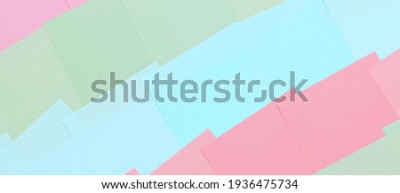 Abstract pastel background from colored note paper. Beautiful delicate background pink, green, blue. Banner.