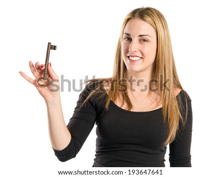 Blonde girl holding vintage key over white background