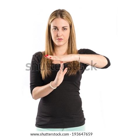 Young girl making time out gesture over white background 