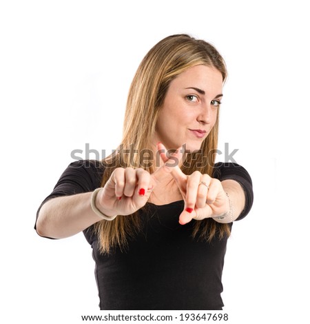 Blonde girl doing NO gesture over white background 