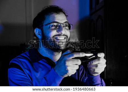 arabic guy playing console games alone