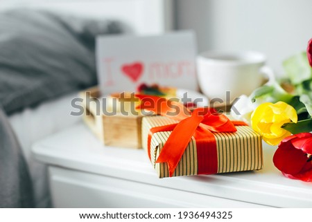 Close-up of gift present box for Mother's day. Festive brunch or breakfast. Good morning concept.