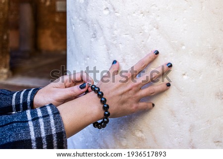 hands of a young girl demonstrating a black Shungite bracelet.

 Royalty-Free Stock Photo #1936517893