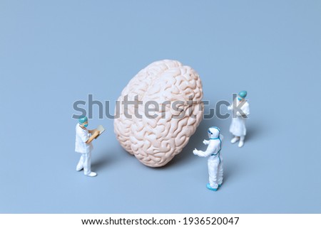 Miniature Doctor checking and analysis alzheimer's disease and dementia of brain, Science and medicine concept Royalty-Free Stock Photo #1936520047