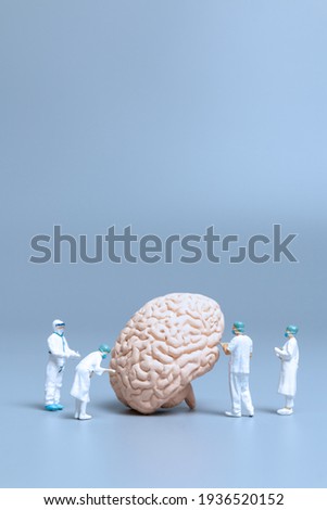 Miniature Doctor checking and analysis alzheimer's disease and dementia of brain, Science and medicine concept Royalty-Free Stock Photo #1936520152