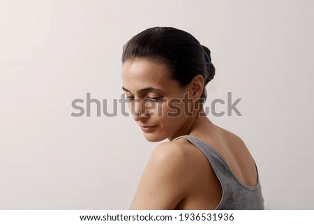 Woman of 30 very slim in profile, half body. Moods concept. Royalty-Free Stock Photo #1936531936