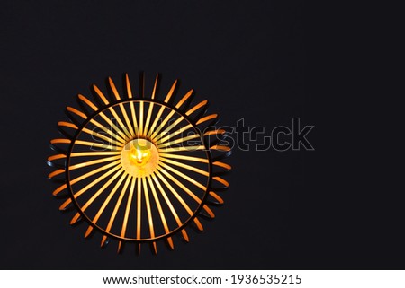vintage style hanging light fixtures,
Low angle view of Beautiful round chandelier hanging in restaurant. Lame warm yellow-white light on ceiling with blurred background. Select focus. Decorative lamp