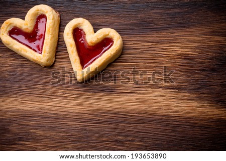 Heart-shaped cookies on a wooden background. Studio picture.