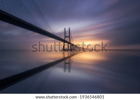 Amazing sunrise in Lisbon, watching the Vasco da Gama Bridge start to light up Royalty-Free Stock Photo #1936546801