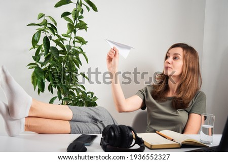 Woman procrastinate at home workplace. Remote work and home office problem Royalty-Free Stock Photo #1936552327