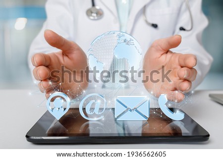 Doctor shows online contact icon on tablet.