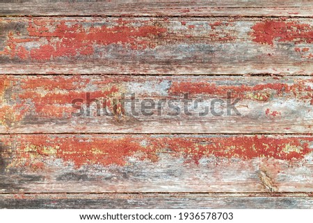 Old, cracked and peeled paint. Red brown boards. Aged dilapidated wall. Rustic background. Place for text, copy space.