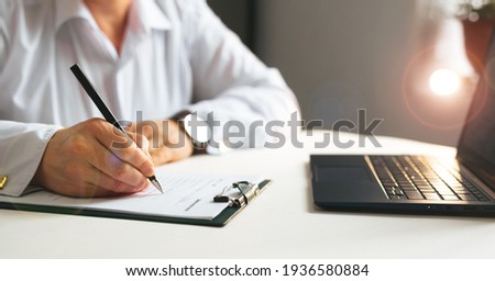 Businesswoman signing a legal document. 