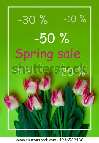Baner for the site with the inscription discount. Spring sale. Tulips on a green background. Poster design.