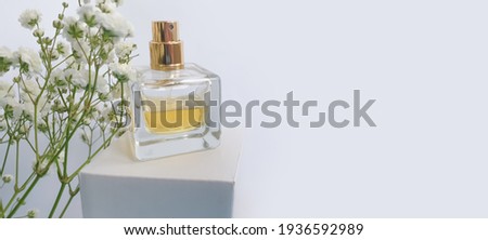 bottle perfume flower on a colored background