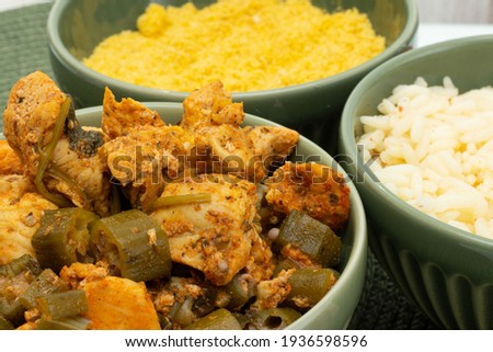 delicious brazilian meal in three  bowls  full of  piece of chicken, rice and flour