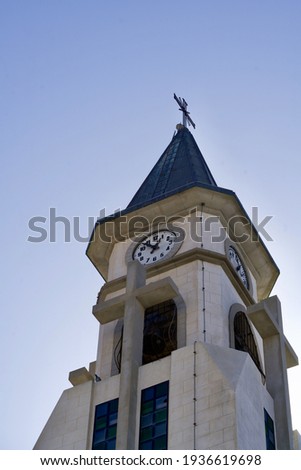 Steeple with crosses under a blue sky
