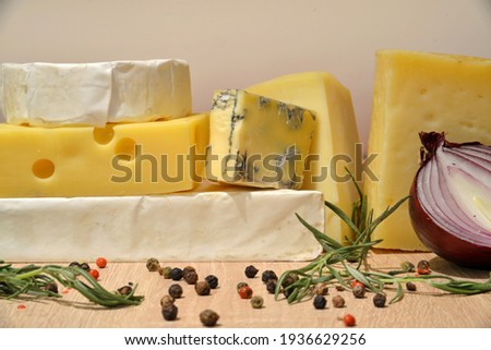 Different types of cheese on wooden desk