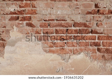 brick wall with cracked and demolition stones, facade with light painted wall, background for template, no person