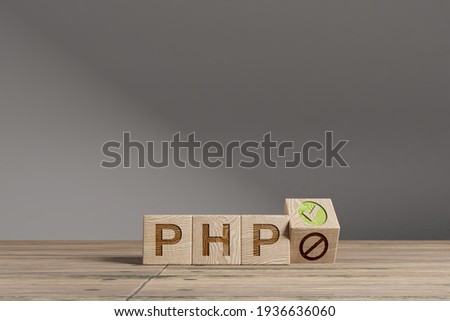 Wood cubes with acronym 'PHP' on a beautiful wooden table, studio background. Business concept with copy space.