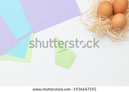 DIY Children's Easter craft bunny with an egg. Step 11. Easter paper step by step instructions. Happy bunny holds egg. Children's Art Project, needlework, crafts for children, springtime
