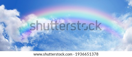 Beautiful sunny summer blue sky panoramic rainbow - fluffy clouds with a giant arcing rainbow against a beautiful summertime blue sky with plenty of space for text
 Royalty-Free Stock Photo #1936651378
