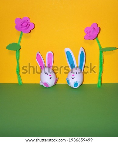 Easter bunnies from an egg on a yellow background.