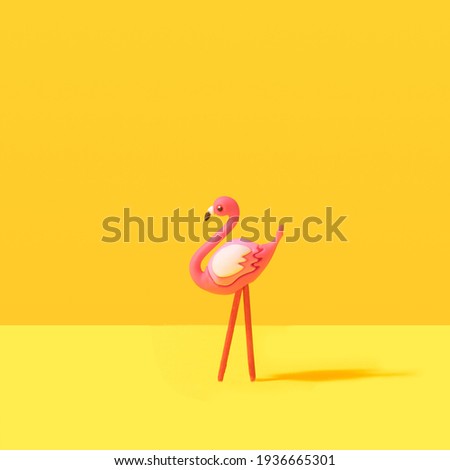 Minimal summer flamingo toy tropical concept. Illuminating yellow background.