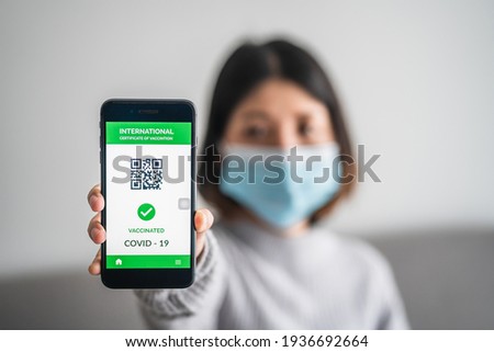 close up of view hands women holding smartphone display on app mobile vaccinated COVID-19 or coronavirus certificate, immunity vaccine passport, new normal travel of tourist concept. Royalty-Free Stock Photo #1936692664