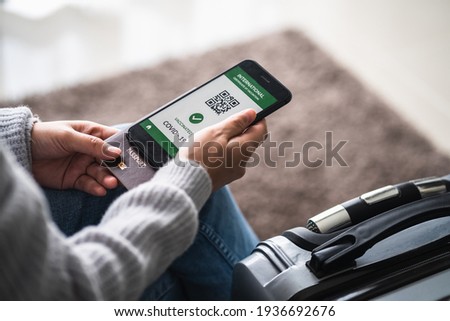 close up of view hands women holding smartphone display on app mobile vaccinated COVID-19 or coronavirus certificate, immunity vaccine passport, new normal travel of tourist concept. Royalty-Free Stock Photo #1936692676