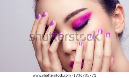 Asian female closeup colorful eyeshadow with extreme long false eyelashes. Eyelash Extensions. Makeup, Cosmetics, Beautiful cosmetics makeup concept.