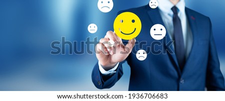 business man holding smiling face icons Royalty-Free Stock Photo #1936706683