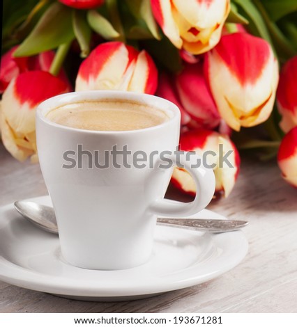 Coffee cup and  tulips. Selective focus