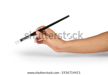 Hand holding a painting brush isolated on white 