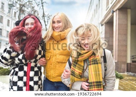 Holidays, tourism concept - three beautiful girls tourists, having fun Running through the bright city