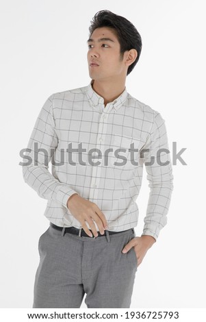 Portrait of self confidence young and handsome business Asian man with friendly and charming successful emotion pose against isolated on white background with hand in pocket.
