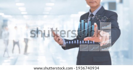 Businessman using digital tablet analysing financial data, market report, economic growth graph chart on virtual screen. Business strategy analysis, digital marketing plan, business and technology 
