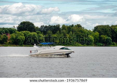 A hydrofoil boat moves at high speed along the river