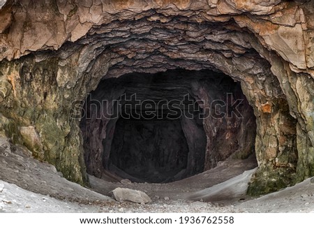 The entrance to the old abandoned limestone adits. Royalty-Free Stock Photo #1936762558