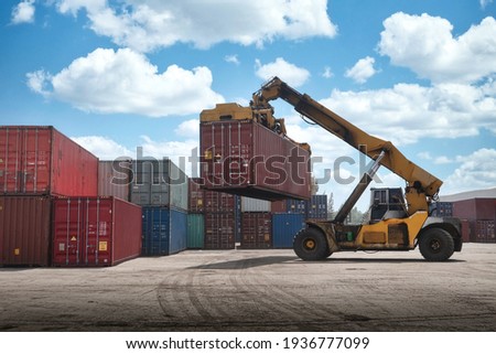 Crane lifting up container box loading to truck in import export logistic zone Royalty-Free Stock Photo #1936777099