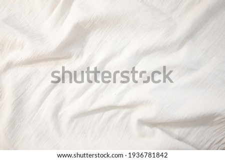 Fabric backdrop White linen canvas crumpled natural cotton fabric Natural handmade linen top view background Organic Eco textiles White Fabric linen texture  Royalty-Free Stock Photo #1936781842