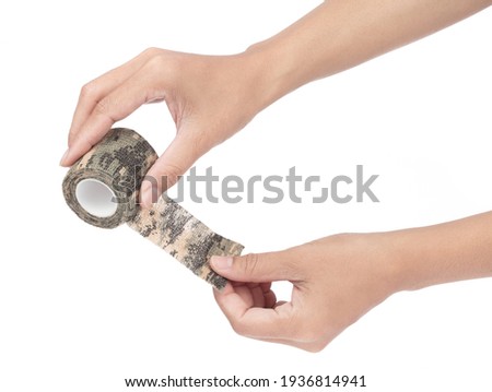 Hand holding Wrap Tape military isolated on a white background.