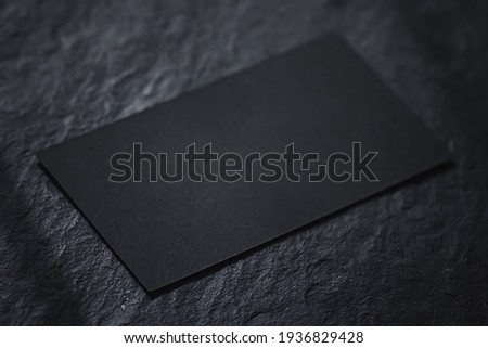 Black business card on dark stone flatlay background and sunlight shadows, luxury branding flat lay and brand identity design for mockups