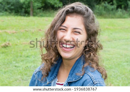 Portrait of Happy Brunette Woman smile in outdoor with green field garden background