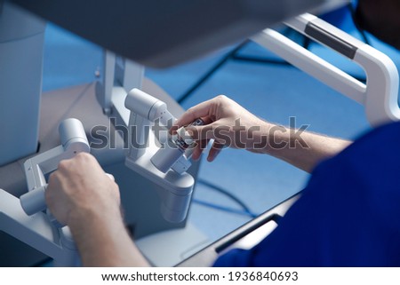 preparation for performing robotic surgery, doctor's hands Royalty-Free Stock Photo #1936840693