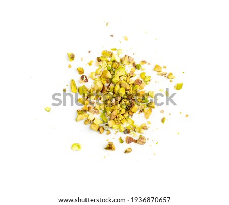 Scattered pistachio nut pieces isolated. Break chopped pistachios pile, fried baked diced pistache on white background top view Royalty-Free Stock Photo #1936870657